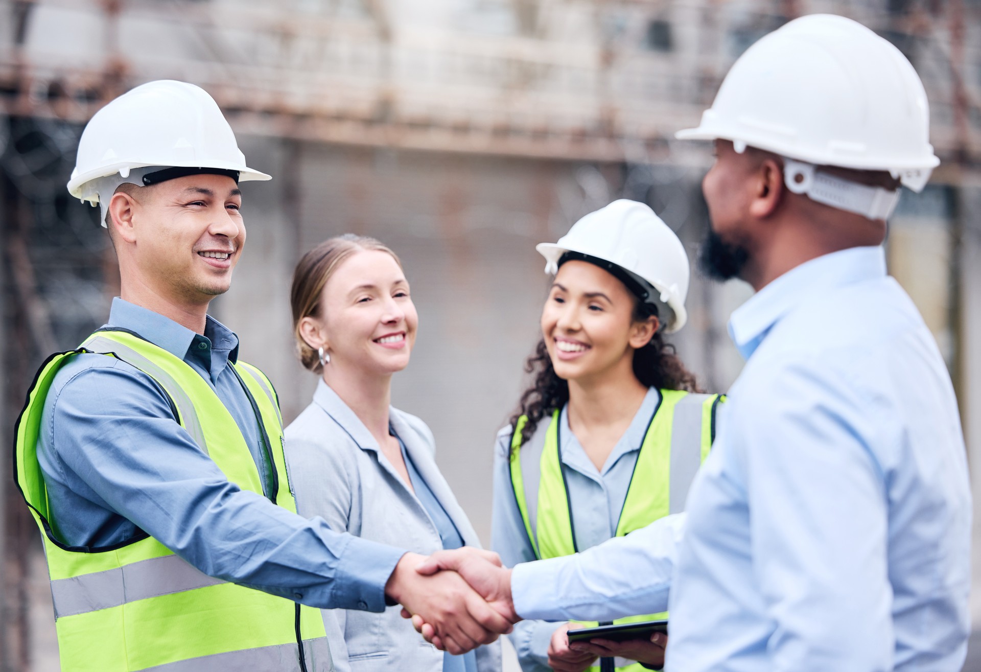 Shot of two architects shaking hands at a building site