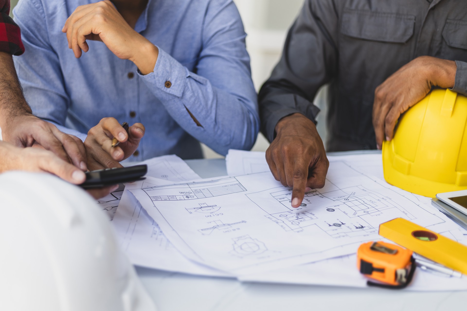 Contractor engineer discusses with an architect the construction of a home renovation project at the job site.